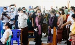 Pemimpin Myanmar Aung San Suu Kyi (tengah) meninjau langsung pelaksanaan vaksinasi kepada petugas kesehatan di sebuah rumah sakit di Naypyitaw, Myanmar, Rabu, 27 Januari 2021.