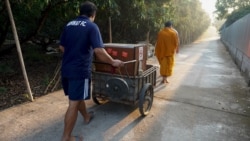 Pa Book Temple's Buddhist monks use a mobile food cabinet to collect alms to reduce plastic waste.