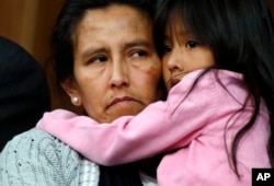 Jeanette Vizguerra, left, a Mexican woman seeking to avoid deportation from the United States, cradles her 6-year-old daughter, Zuri, during a news conference in a church in which she and her children have taken refuge, Feb. 15, 2017, in Denver.