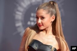 FILE - Ariana Grande arrives at the MTV Video Music Awards at The Forum in Inglewood, California, on Aug. 24, 2014.