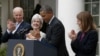 President Barack Obama and Vice President Joe Biden stand with outgoing Health and Human Services Secretary Kathleen Sebelius, second from left, and his nominee to be her replacement, Budget Director Sylvia Mathews Burwell, April 11, 2014.