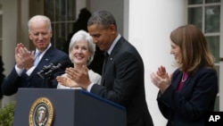 President Barack Obama and Vice President Joe Biden stand with outgoing Health and Human Services Secretary Kathleen Sebelius, second from left, and his nominee to be her replacement, Budget Director Sylvia Mathews Burwell, April 11, 2014.