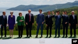 FILE - The G-7 summit participants pose for a photo in Charlevoix, Canada, June 8, 2018. 