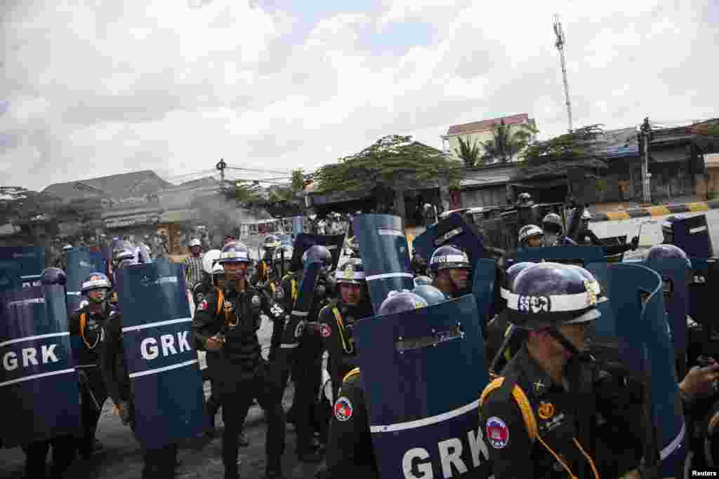 Police use batons and shields during clashes with garment workers in Phnom Penh, Cambodia, Nov. 12, 2013. 