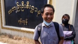 Associated Press (AP) photographer Thein Zaw stands outside Insein prison in Yangon on March 24, 2021, after being released with coup detainees who had been held for taking part in demonstrations against the military coup. (Photo by STR / AFP)