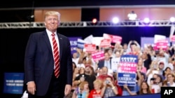 President Donald Trump stands before speaking at a rally at the Phoenix Convention Center, Aug. 22, 2017, in Phoenix.