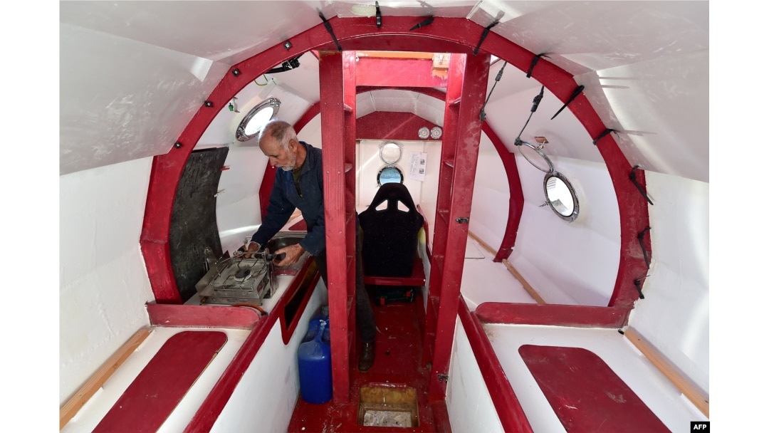 Jean-Jacques Savin works on the construction of a ship made from a barrel on Nov. 15, 2018 at the shipyard in Ares, southwestern France.