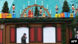 A man walks past a closed stall that is set up for the Christmas Market in Essen, western Germany, on October 29, 2020, during the ongoing novel coronavirus (Covid-19) pandemic.