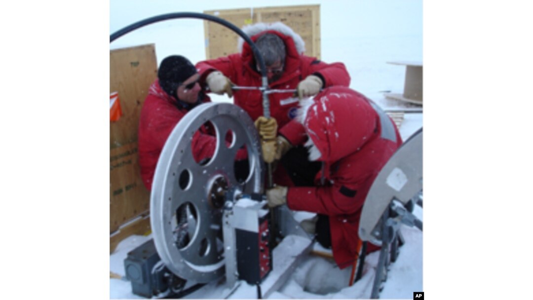 Near U.S. Antarctic McMurdo station scientists practice lowering the ocean profiler down a hole into the ocean beneath the ice.