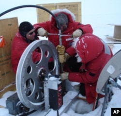 Near U.S. Antarctic McMurdo station scientists practice lowering the ocean profiler down a hole into the ocean beneath the ice.