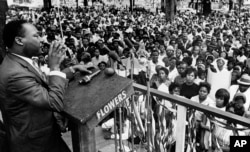 The Rev. Martin Luther King Jr. addresses a crowd of some 3,000 persons, April 30, 1966, in Kelly Ingram Park on the last day of his three-day whistle-stop tour of Alabama.