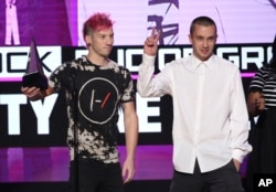Josh Dun, left, and Tyler Joseph, of Twenty One Pilots, accept the award for favorite duo or group - pop/rock at the American Music Awards at the Microsoft Theater on Nov. 20, 2016, in Los Angeles.