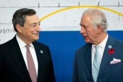 Italy's Prime Minister Mario Draghi greets Britian's Prince Charles as he arrives to attend the G20 Summit at the La Nuvola conference centre in Rome, Oct. 31, 2021. (Aaron Chown/Pool via Reuters)