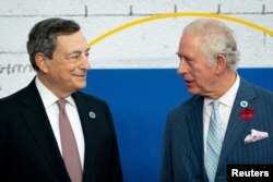 Italy's Prime Minister Mario Draghi greets Britian's Prince Charles as he arrives to attend the G20 Summit at the La Nuvola conference centre in Rome, Oct. 31, 2021. (Aaron Chown/Pool via Reuters)