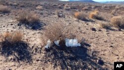 This undated photo provided by the U.S. National Park Service shows toilet paper strewn throughout Death Valley National Park, Calif. National parks across the United States are scrambling to clean up and repair damage caused by visitors and storms during the government shutdown.