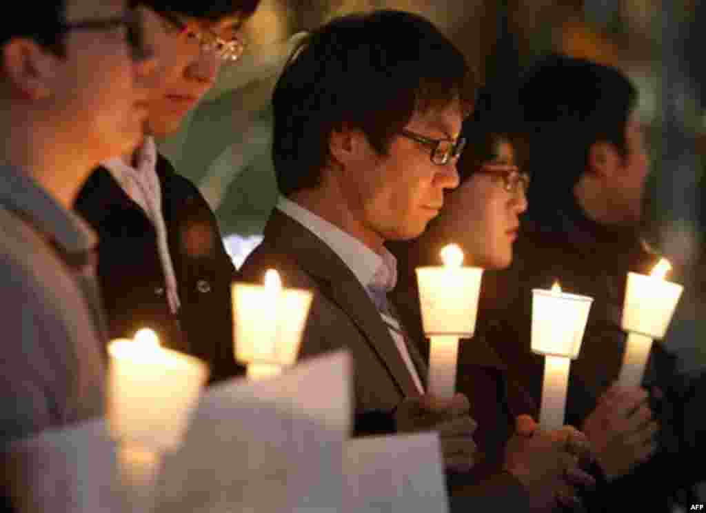 South Koreans take moment of silence for South Korean marines killed in a North Korean bombardment during a rally against North Korea's attack onto South Korean island, in Seoul, South Korea, Tuesday, Nov. 23, 2010. North Korea shot dozens of rounds of ar