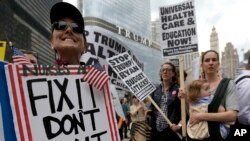 Protesters in Chicago gather across the Chicago River from Trump Tower to rally against the effort to overhaul the Affordable Care Act, March 24, 2017.