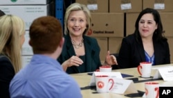 Democratic presidential candidate Hillary Rodham Clinton, center, speaks during a small business roundtable, April 15, 2015, in Norwalk, Iowa.