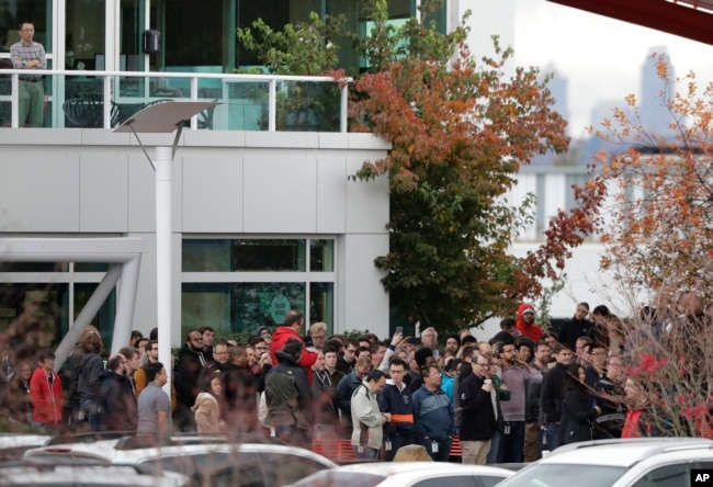 Google employees gather in a courtyard as they take part in a walkout from their jobs at the Google campus in Kirkland, Washington, Nov. 1, 2018.