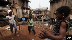Children play in the Makoko slum in Lagos, Nigeria, where houses sit on stilts above polluted waters of the Lagos lagoon, January 21, 2011.