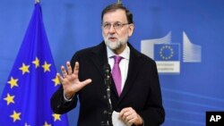 Spanish Prime Minister Mariano Rajoy speaks with the media as he arrives for an EU-Sahel meeting at EU headquarters in Brussels on Friday, Feb. 23, 2018.