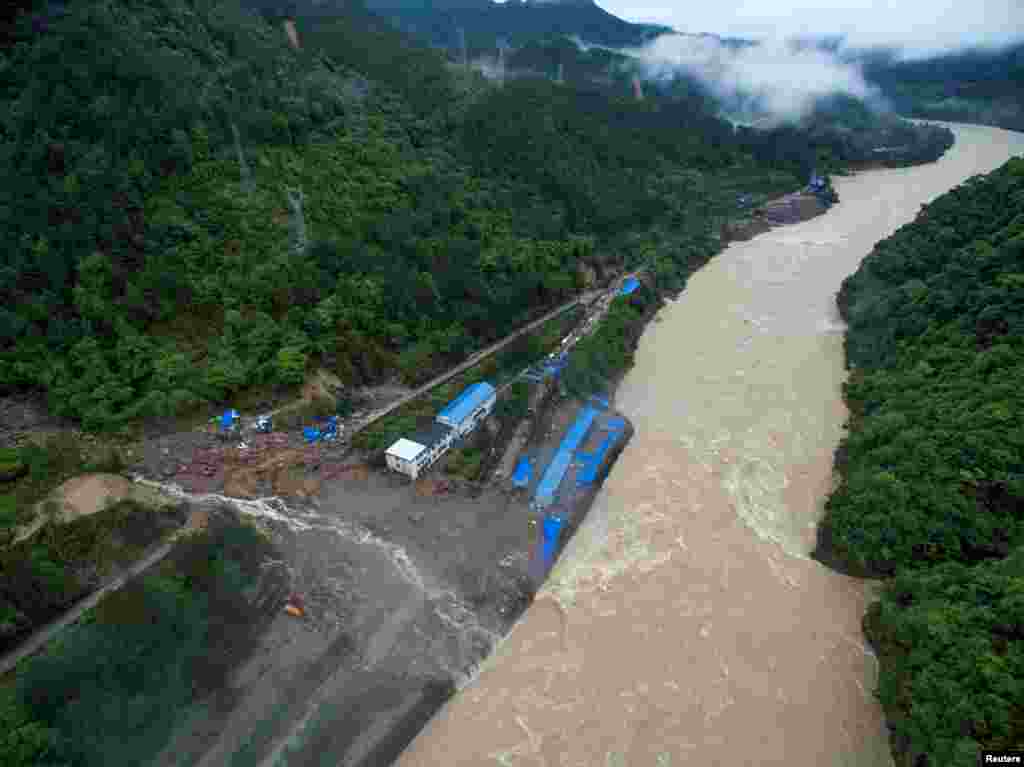 An aerial view shows buildings at a hydroelectric power station under construction are hit by landslide in Sanming, Fujian Province, China.