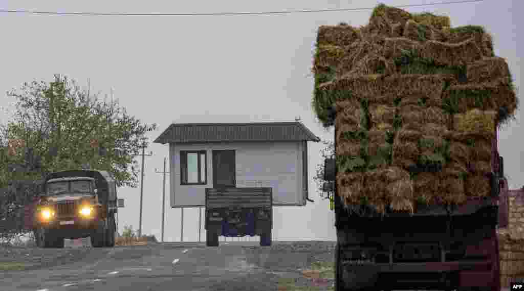 A truck carries a barn as Armenian refugees leave the village of Nor Maragha near Agdam.