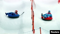 Visitors enjoy snow rides in the new Snow City at Al Othaim Mall in Riyadh, Saudi Arabia on July 26, 2016.