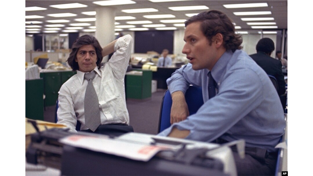 FILE - Reporters Bob Woodward, right, and Carl Bernstein, whose reporting of the Watergate case won them a Pulitzer Prize, sit in the newsroom of The Washington Post in Washington, May 7, 1973.