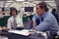 FILE - Reporters Bob Woodward, right, and Carl Bernstein, whose reporting of the Watergate case won them a Pulitzer Prize, sit in the newsroom of The Washington Post in Washington, May 7, 1973.
