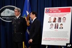 Mark Flynn, Director General for the Royal Canadian Mounted Police (L), and Assistant Attorney General for National Security John Demers, attend a news conference, Oct. 4, 2018, at the Justice Department in Washington.