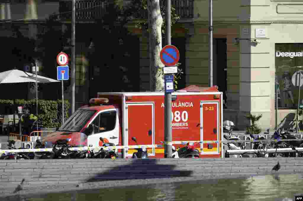 A policeman stands next to an ambulance after a van ploughed into the crowd, injuring several persons on the Rambla in Barcelona on Aug. 17, 2017