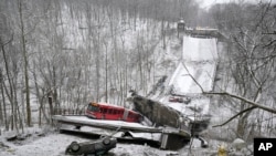 A Port Authority bus that was on a bridge when it collapsed Jan. 28, 2022, is visible in Pittsburgh's East End.