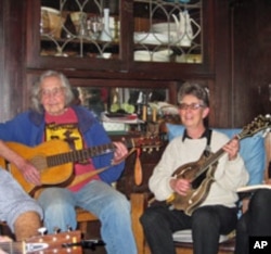 Faith Petric (left) is joined by long-time club member Estelle Freedman on the mandolin at a recent jam session.