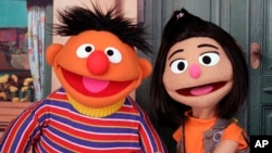 Ernie, a muppet from the popular children's series "Sesame Street," appears with new character Ji-Young, the first Asian American muppet, on the set of the long-running children's program in New York on Nov. 1, 2021. (AP Photo/Noreen Nasir)