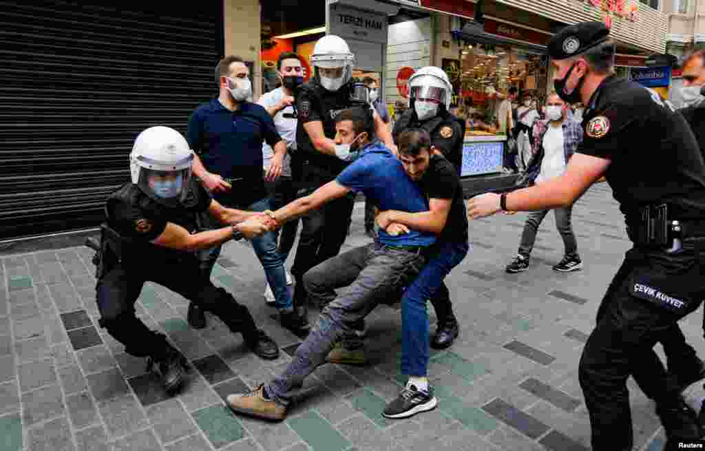 Police officers detain a demonstrator as he resists during a protest against the ban of this year&#39;s Peace Day rally, in Istanbul, Turkey, Sept. 5, 2021.