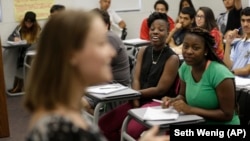 Students listen to their teacher during an English class at an Upward Bound program that serves as a pathway to college for students from low-income families, in New York.