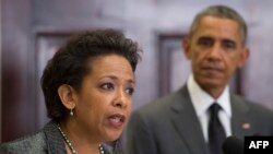 US President Barack Obama (R) looks on as his nominee for US Attorney General, Loretta Lynch (L), the US attorney in Brooklyn, NY, speaks during an event at the White House in Washington, DC, November 8, 2014. 