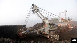 A huge excavator digs in a giant open-pit lignite mine near the Czech Republic town of Most, Nov. 6, 2015. The fossil fuel is a major source of greenhouse gases.