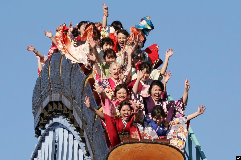 Women celebrating their 20th year ride a roller coaster at Toshimaen amusement park on Coming of Age Day, a national holiday, in Tokyo, Japan.