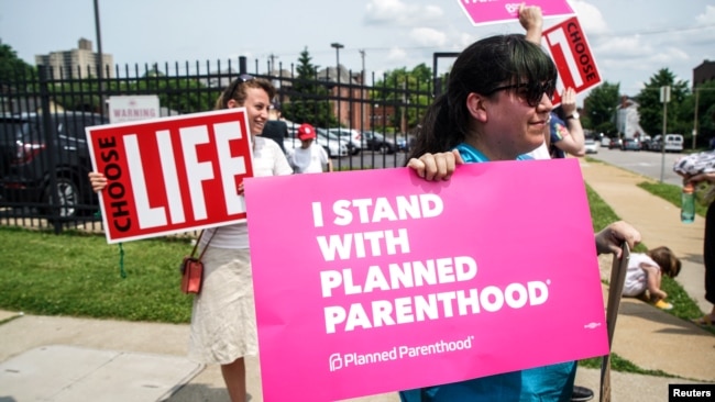 Pro-choice and anti-abortion protesters stand outside of Planned Parenthood as a deadline looms to renew the license of Missouri's sole remaining Planned Parenthood clinic in St. Louis, May 31, 2019.