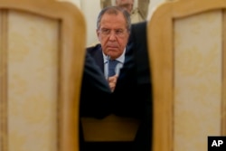 Russian Foreign Minister Sergey Lavrov listens to his counterparts from Sudan and South Sudan during their trilateral meeting in Moscow, Sept. 10, 2015.