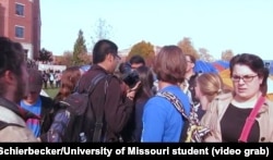 University of Missouri student photographer Tim Tai is blocked from taking photographs by student protesters in Columbia, Mo., Nov. 9, 2015.