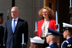 Secretary of Defense Jim Mattis and Macedonian Defense Minister Radmila Sekerinska, right, stand at attention during a ceremony welcoming Sekerinska at the Pentagon, May 1, 2018.