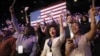 Supporters of President Barack Obama react to favorable media projections at the McCormick Place during an election night watch party in Chicago, Tuesday, Nov. 6, 2012.