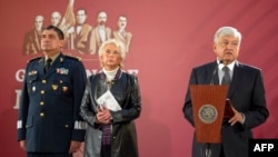 FILE - Mexico's President Andres Manuel Lopez Obrador, accompanied by Secretary General of Defense Luis Cresencio Sandoval (L) and Interior Minister Olga Sanchez Cordero, gives a press conference at the National Palace in Mexico City, Dec. 3, 2018.