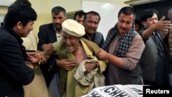 FILE - A father of a member of the Hazara community who was killed by unidentified gunmen mourns the death of his son at a hospital in Quetta, Pakistan, April 22, 2018. 