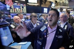 Specialist Ronnie Howard, foreground, works with traders at his post on the floor of the New York Stock Exchange, Friday, June 24, 2016. U.S. stocks are plunging in early trading after Britons voted to leave the European Union. (AP Photo/Richard Drew)