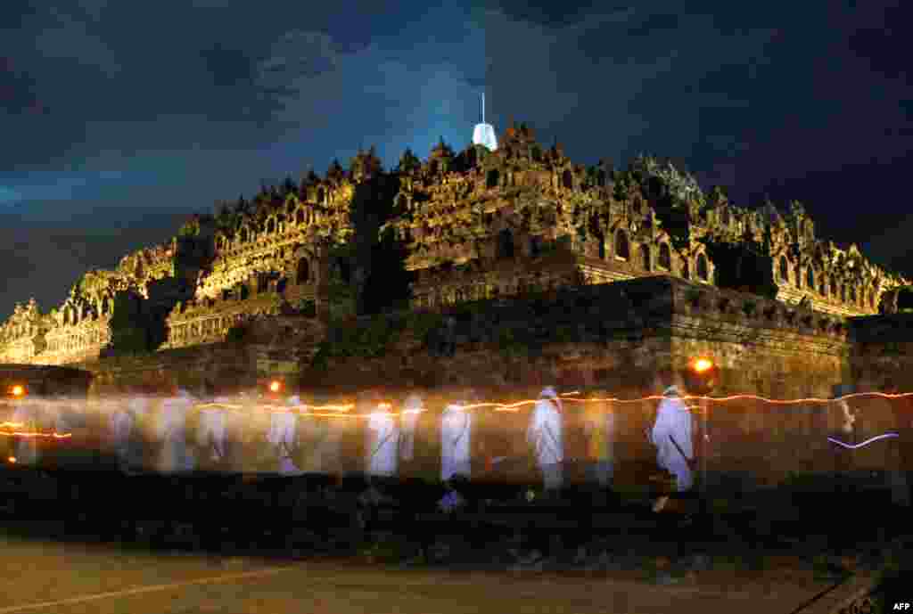 May 17: Indonesian Buddhists walk around Borobudur temple during a celebration of Vesak day, which marks the birth, enlightenment and demise of Buddha, in Central Java, Indonesia. (AP)