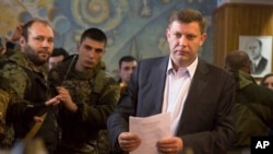 FILE - Pro-Russian rebel leader Alexander Zakharchenko is seen approaching a ballot box in separatist-organized elections in the city of Donetsk, eastern Ukraine, Nov. 2, 2014.